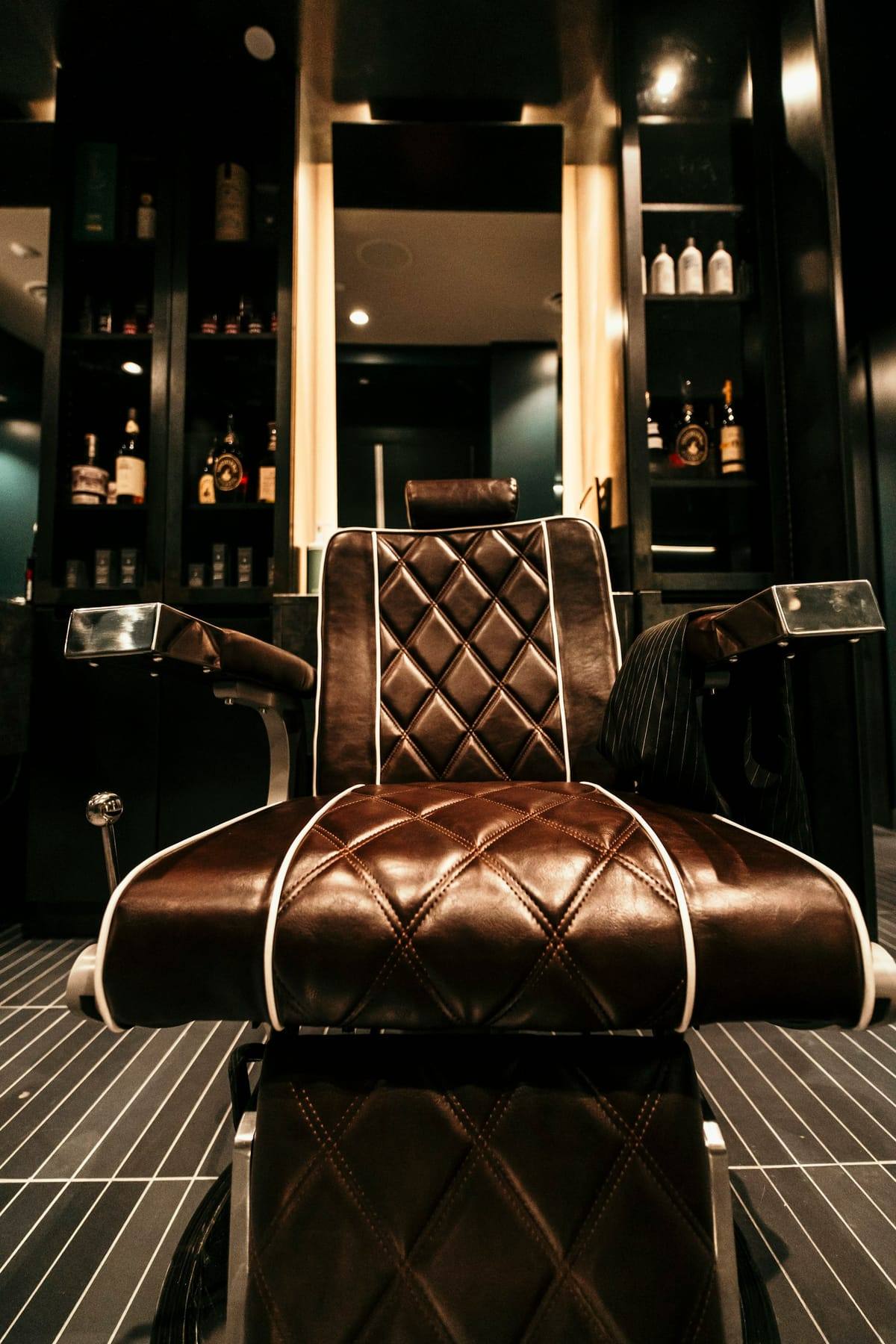 Diamond-stitched leather chair with copper trim