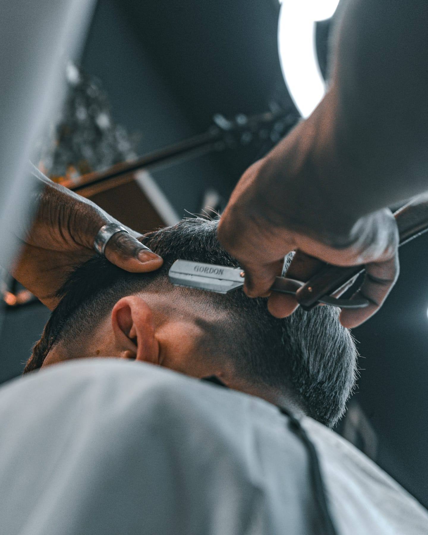Barber edging a crisp line-up with a trimmer