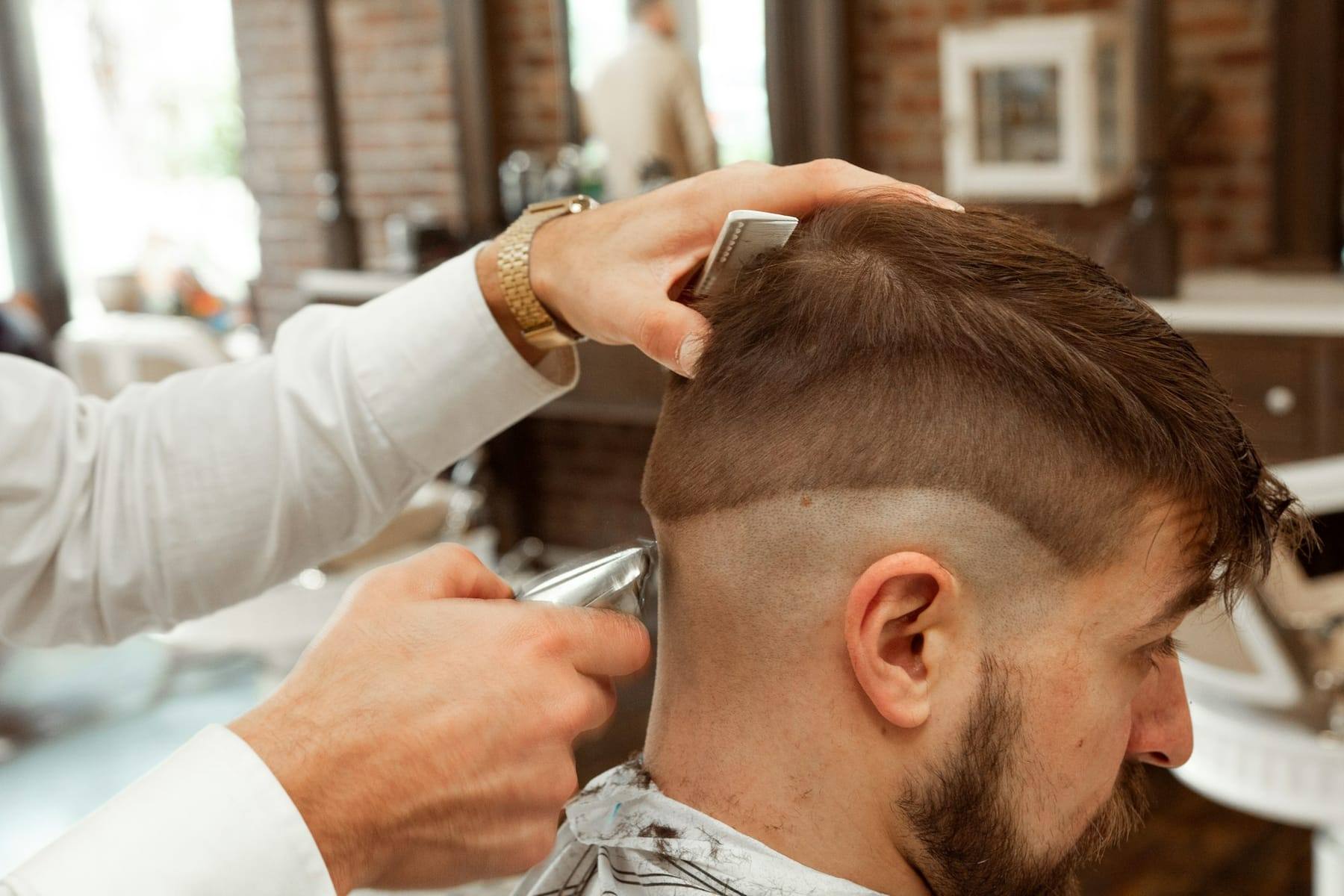 Barber finishing a classic taper with clippers